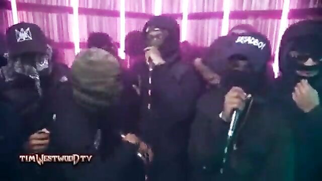 Masked black men in hoodies group session at Tim Westwood TV party