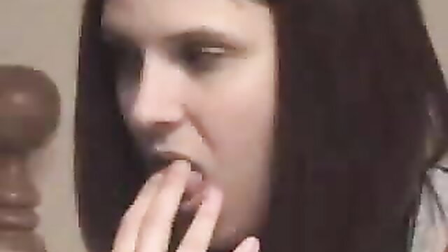 Closeup of pale brunette woman teasing open mouth with fingers, lesbian tease