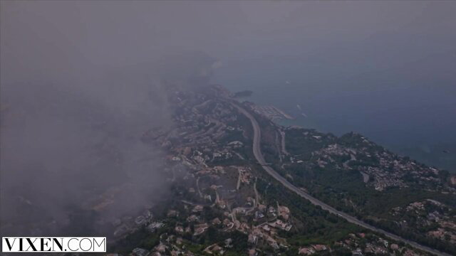 Aerial view of misty coastal cityscape with Vixen watermark