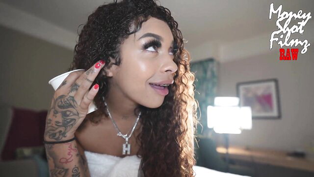 Curly haired mixed baddie in towel touches ear, big tits tease