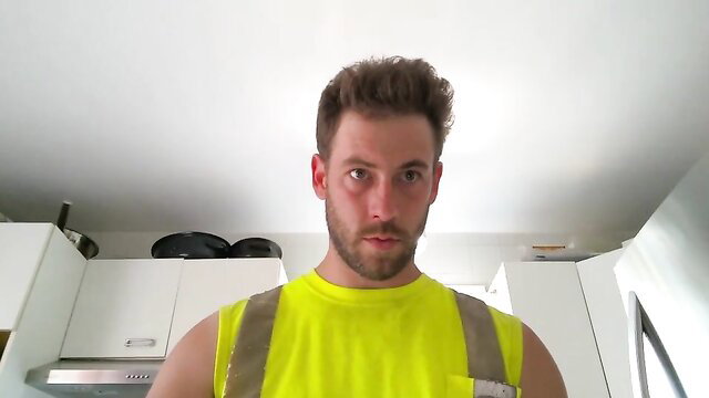 Muscular white guy in yellow hi-vis tank top and vest, fetish master look