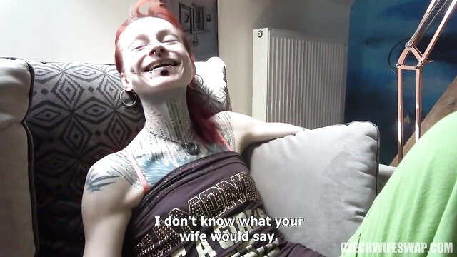 Redhead tattooed alt girl laughing on couch in WifeSwap porn thumbnail