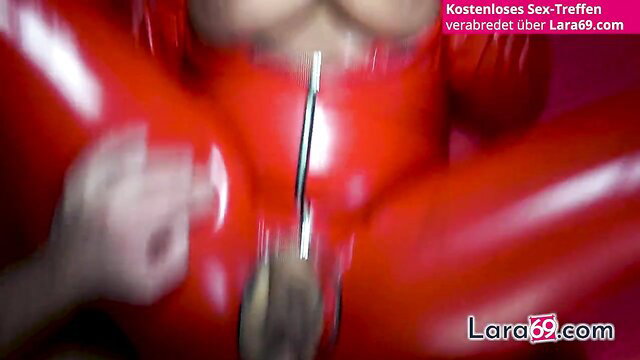 Ashley Cumstar in red latex bodysuit with dildo penetration
