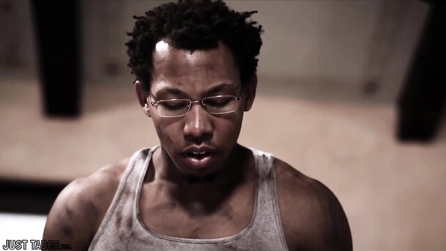 Muscular black blind man in tank top at doctor's exam