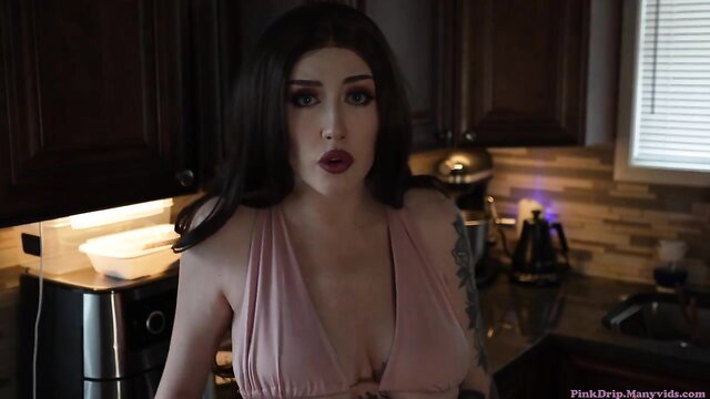 Pink Drip in pink dress, teasing cleavage in kitchen