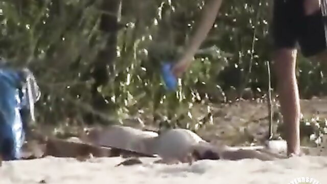 Drunk naked girl sunbathing nude on beach, fully exposed body