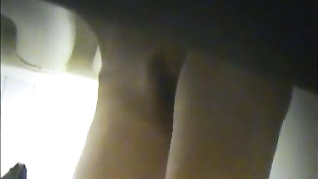 Skinny woman lotions nude body after shower, wet skin closeup