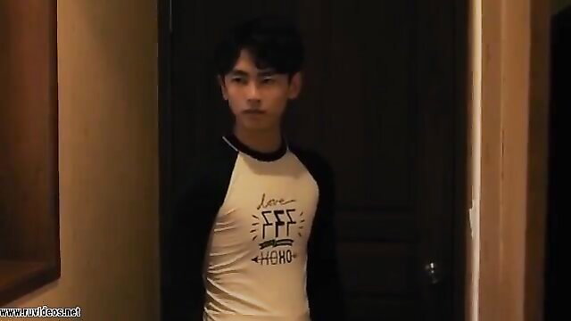 Handsome young Korean guy in tight Love Hero shirt at door, amateur style