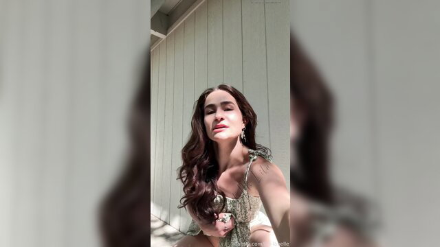 Indian beauty in sexy green strappy top smiling seductively