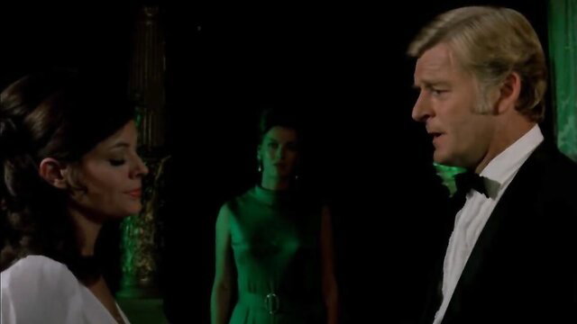 1972 Virgin Witch softcore scene: brunette in white gown with blonde tuxedo man