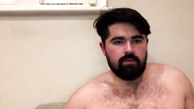 Bearded shirtless bear guy sits nude on cam, hairy chest exposed