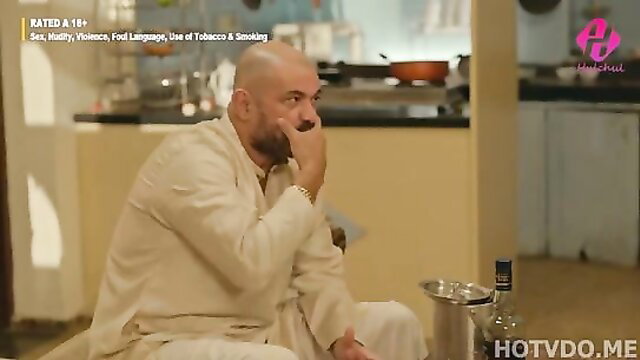 Bald Indian man in white kurta sits pensively in Khatiya Episode 1 Hulchul hot web series