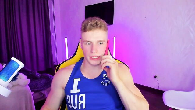 Robust handsome Kurt Hanssen on phone in tank top, Chaturbate gay cam