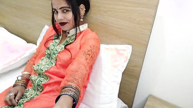 Baby Kajal in orange salwar kameez, seductive pose on bed