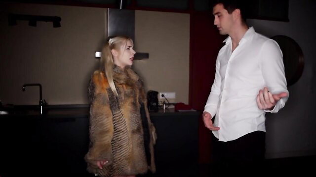 Blonde teen in fur coat chats with handsome guy in kitchen preview