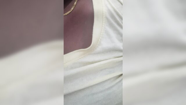 Tamil aunty in white tank top showing cleavage and gold necklace