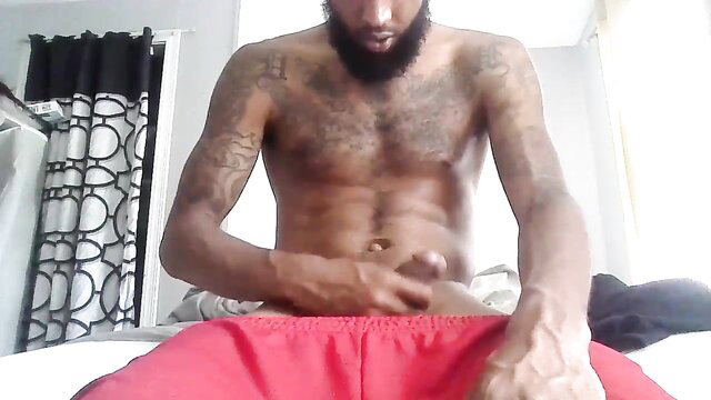 Bearded black twink Vonthedon16408 solo stroking bulge in red shorts