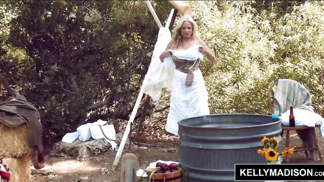 Kelly Madison busty blonde in white dress at outdoor wash site