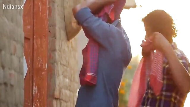 Indian villagers in colorful turbans and shirts outdoors, sunny rural scene