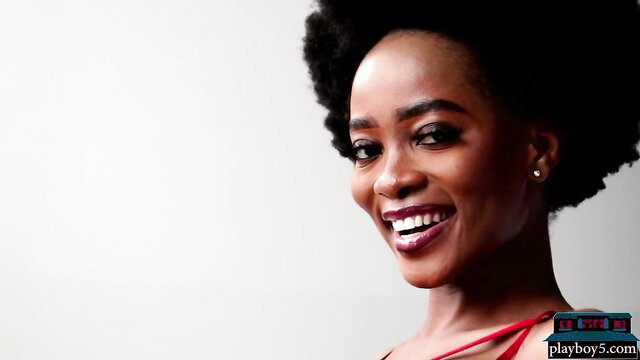 Seductive smiling black teen babe with afro in red lingerie Playboy