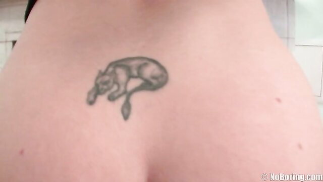 Closeup of woman's curvy ass with panther tattoo above pussy