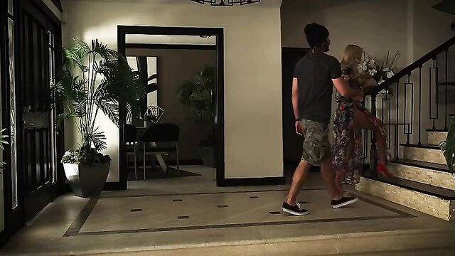 Blonde babe in short dress held by guy on stairs, feet fetish tease