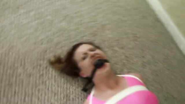 Brunette babe gagged and bound on floor in pink top, tickle fetish