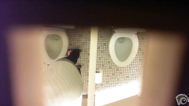 Candid voyeur video of woman peeing in public bathroom urinals