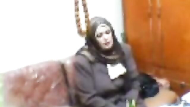 Arab Nik hijab model seated in dark outfit, teasing amateur look