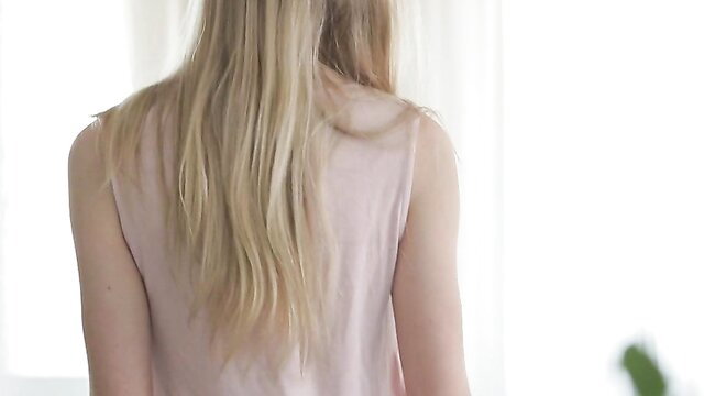 Beautiful blonde Lolly Gartner in pink tank top, long hair back view