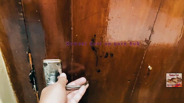 Hand turning door handle on wooden door in steamy Sinhala amateur video