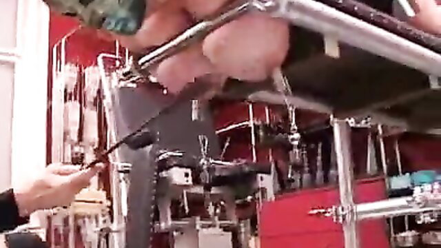 Big-boobed BBW torturing cock with needles on exam table