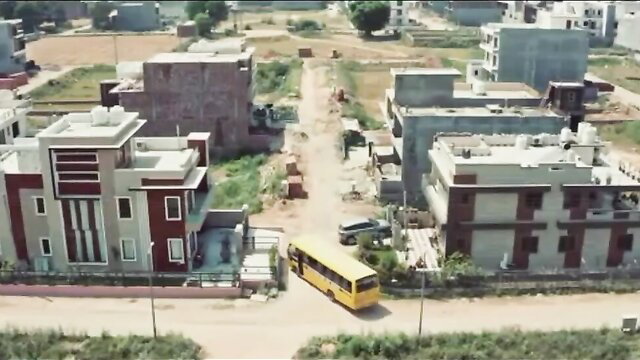 Jua 2023 PrimeShots Episode 05 aerial view of Indian neighborhood with yellow school bus
