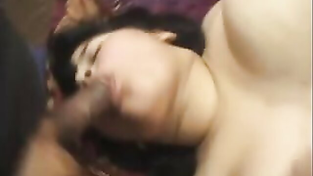 Asian babe's fat tits swing as she's face-fucked hard on bed