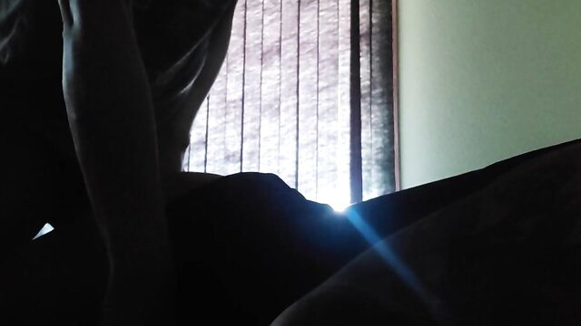 Silhouette of sissy bent over bed awaiting first big black cock