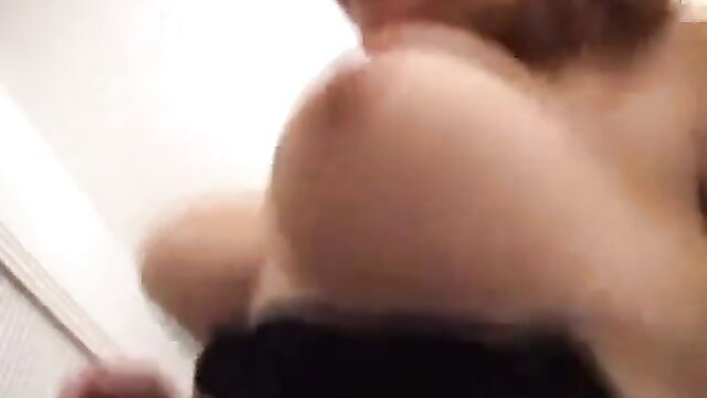 Busty woman smiling during intense titfuck closeup