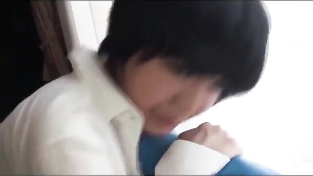 Handsome young Asian man in white shirt and blue pants, closeup profile