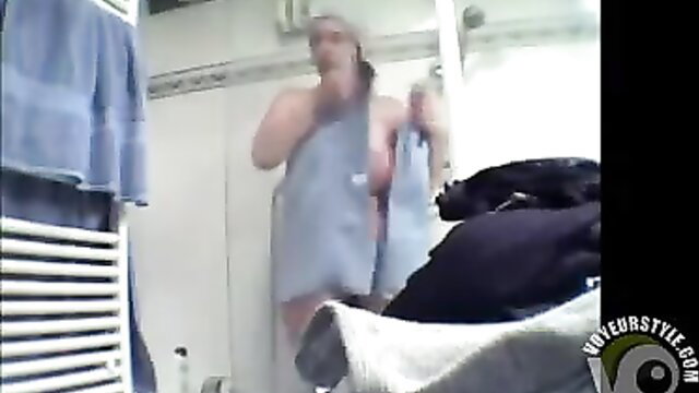 Busty mature woman in towel exposing huge wet tits in shower