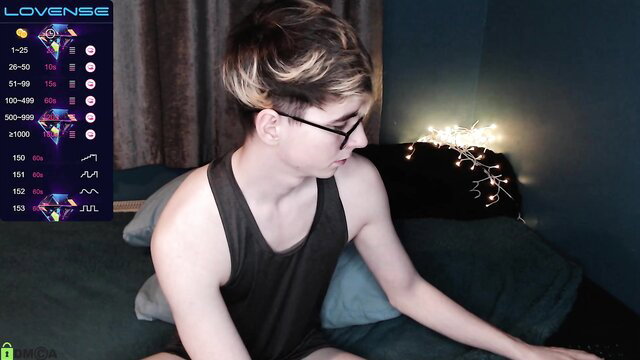 Alfiegreenxxx shirtless in dim-lit room, glasses, undercut hair