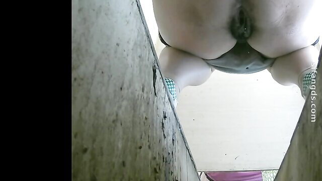 Voyeur closeup of pale girl squatting over toilet pissing