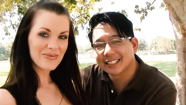 Brandi Edwards smiles with Asian guy outdoors in hotwife tease thumbnail