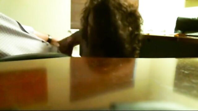 Ebony woman with curly hair gives blowjob under desk at job interview