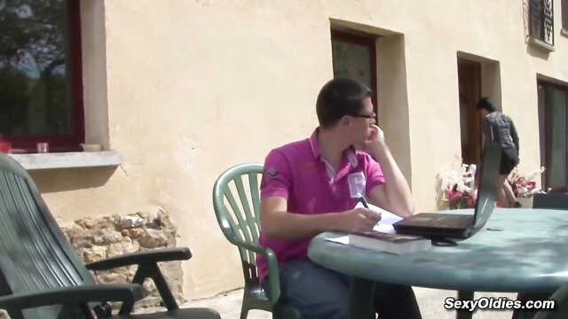 Man in pink shirt working on laptop outdoors, SexyOldies thumbnail