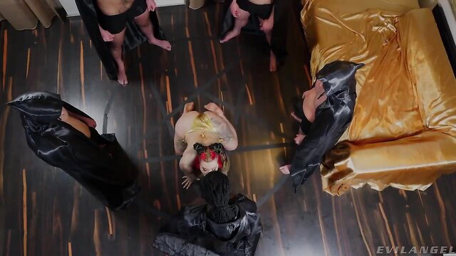 Sabien Demonia bound and surrounded by cloaked men in interracial gangbang