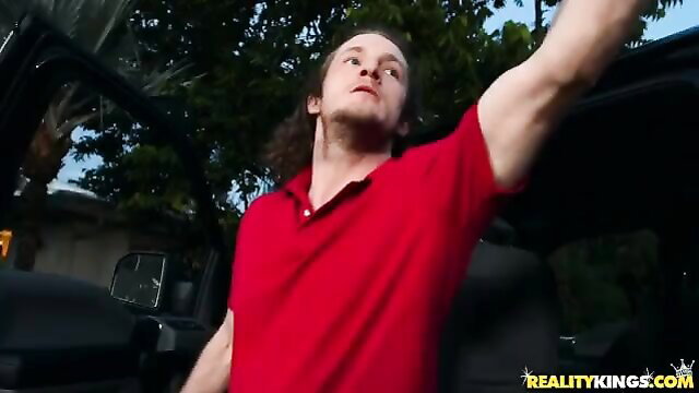 Brick Danger long haired hunk in red shirt by Jeep outdoors Reality Kings