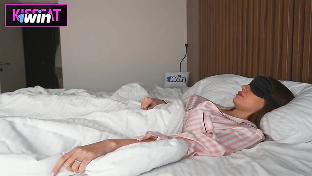 Posh tart in pink silk pajamas sleeping with blindfold on bed