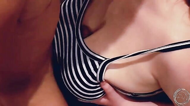 Busty woman in striped swimsuit gets tits squeezed in closeup