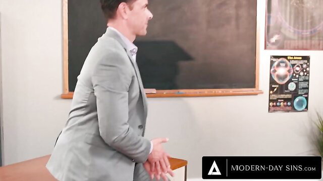 Fiona Frost in gray suit by chalkboard, hot teacher tease