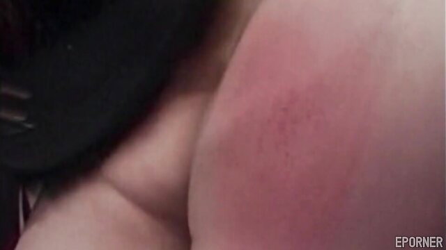 Raunchy lesbian BDSM closeup of spanked red ass cheek