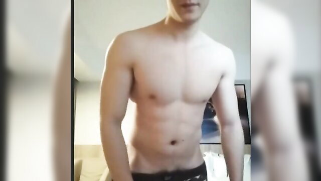 Handsome shirtless Asian soldier flexing abs in tight underwear